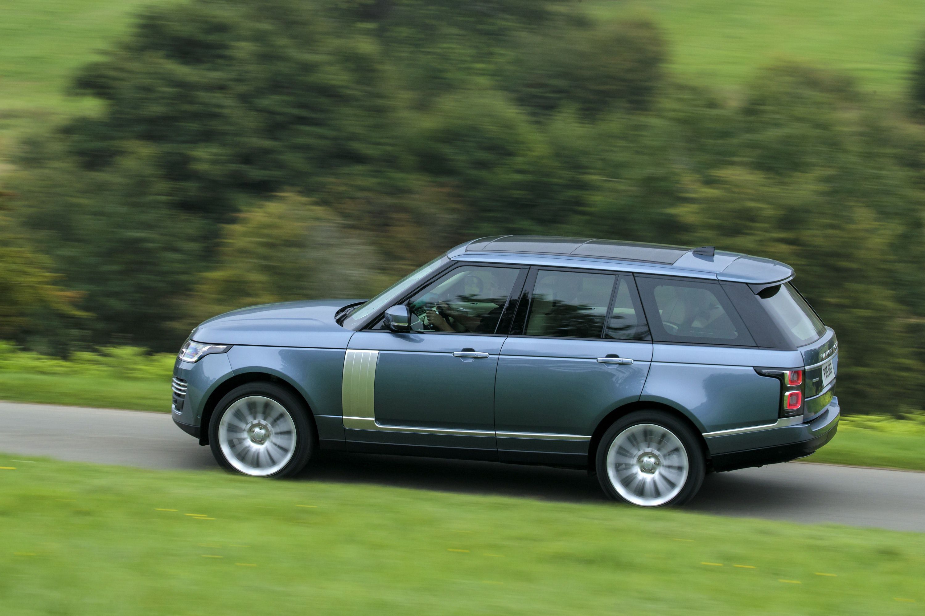Side view of a Range Rover driving on a road